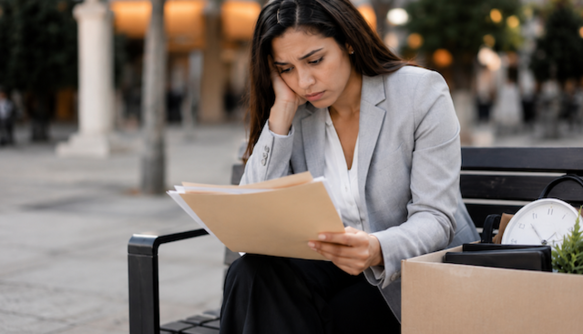 woman on park bench laid off from work